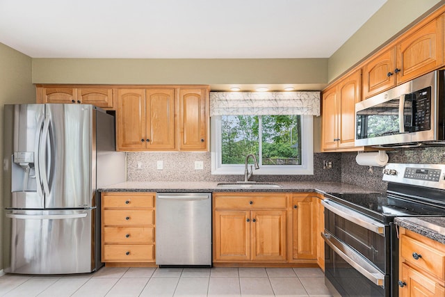 1231 Naples Ct, Ann Arbor, MI 48103 - kitchen with stainless steel appliances, a sink, decorative backsplash, and light tile patterned floors