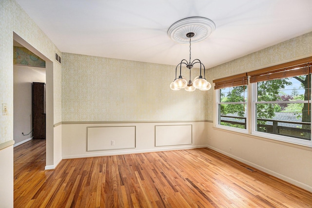 1231 Naples Ct, Ann Arbor, MI 48103 - unfurnished dining area featuring light wood-type flooring, wallpapered walls, a chandelier, baseboards, and wainscoting
