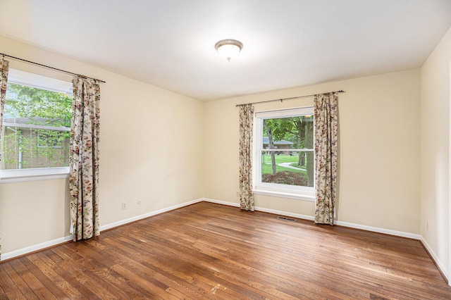 1231 Naples Ct, Ann Arbor, MI 48103 - empty room featuring healthy amount of natural light, wood-type flooring, and baseboards