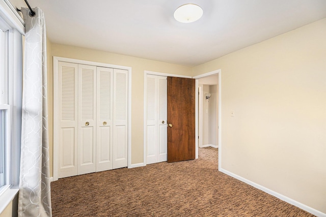 1231 Naples Ct, Ann Arbor, MI 48103 - unfurnished bedroom featuring two closets, carpet floors, and baseboards