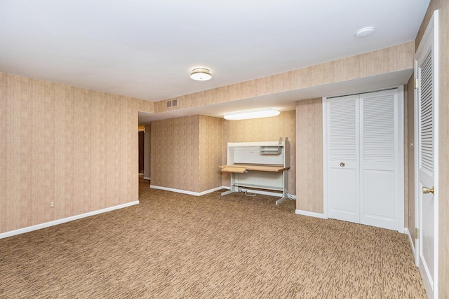 1231 Naples Ct, Ann Arbor, MI 48103 - below grade area featuring wallpapered walls, carpet flooring, and baseboards