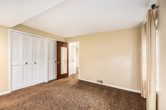 1231 Naples Ct, Ann Arbor, MI 48103 - unfurnished bedroom featuring carpet floors, baseboards, and two closets