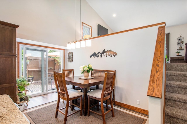 9324 Perry St, Zeeland, MI 49464 - dining area with wood finished floors, stairs, and high vaulted ceiling