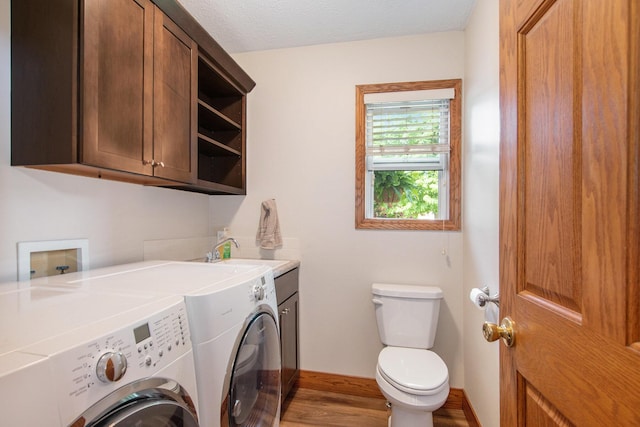 9324 Perry St, Zeeland, MI 49464 - laundry area featuring washing machine and dryer, wood finished floors, and baseboards