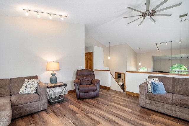 9324 Perry St, Zeeland, MI 49464 - living room with rail lighting, wood finished floors, ceiling fan, baseboards, and lofted ceiling