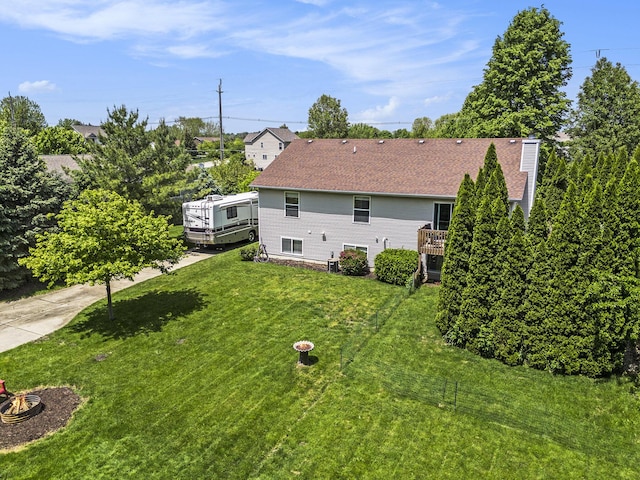 9324 Perry St, Zeeland, MI 49464 - back of house featuring a lawn and central AC