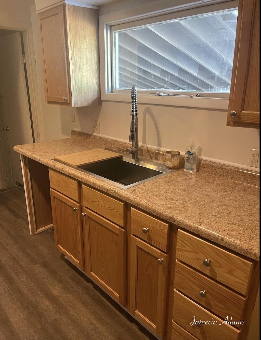 3351 Mona St, Muskegon, MI 49444 - kitchen with a sink, dark wood-type flooring, light countertops, and brown cabinetry
