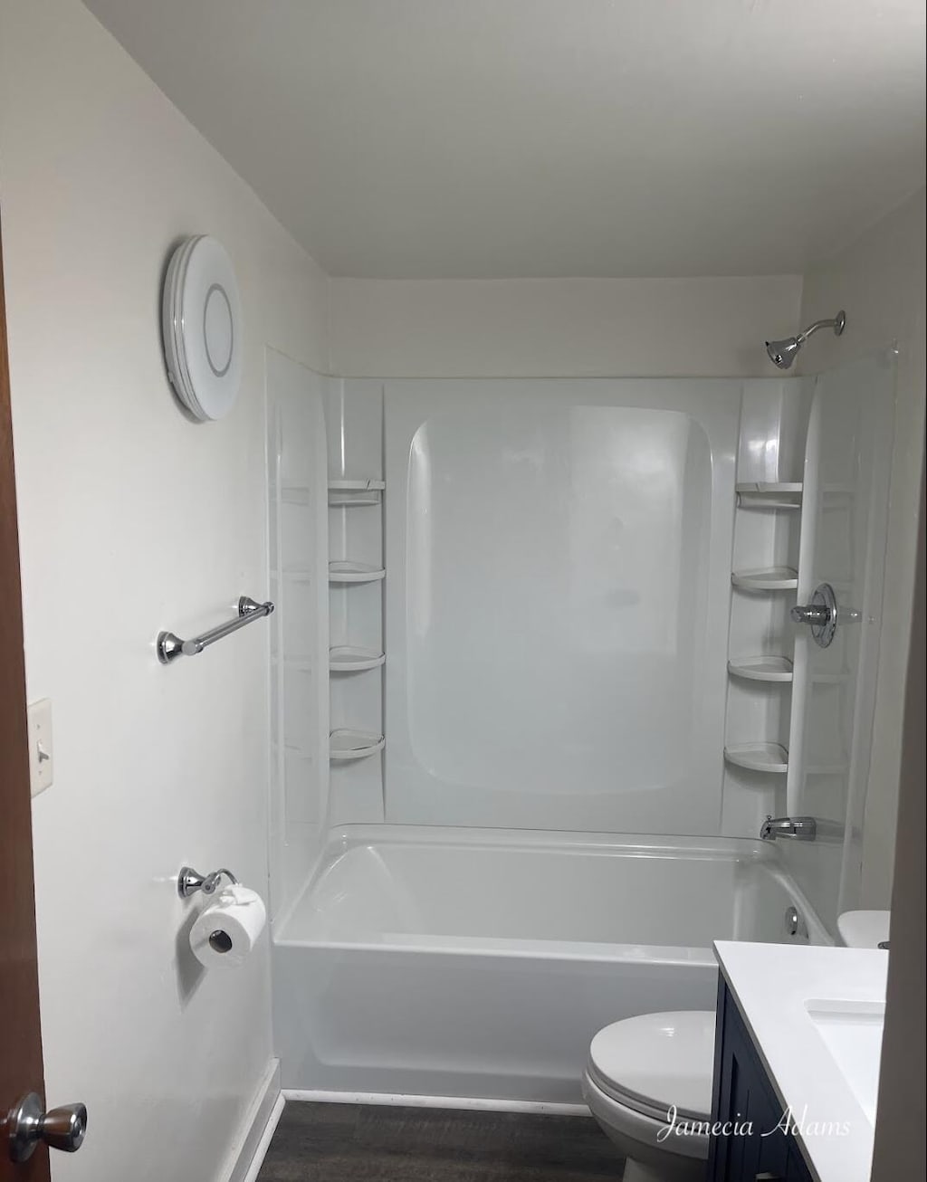 3351 Mona St, Muskegon, MI 49444 - bathroom featuring toilet, vanity, wood finished floors, and shower / bathtub combination