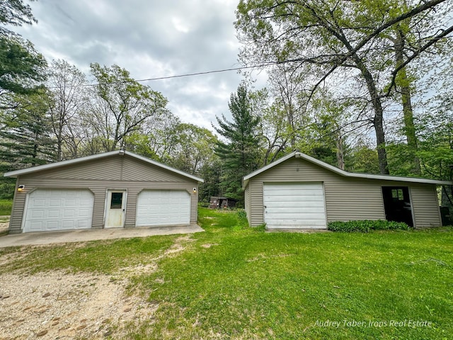 4307 N Mac Rd, Irons, MI 49644 - detached garage featuring view of scattered trees