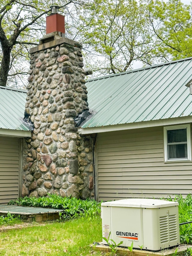 4307 N Mac Rd, Irons, MI 49644 - exterior view of a power unit, metal roof, and a chimney