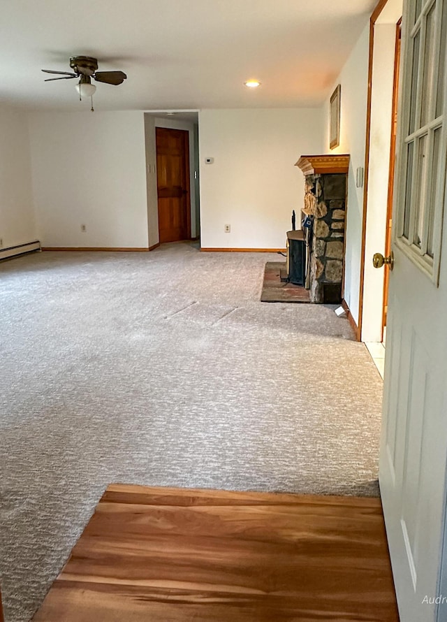 4307 N Mac Rd, Irons, MI 49644 - unfurnished living room with ceiling fan, baseboards, baseboard heating, carpet, and recessed lighting