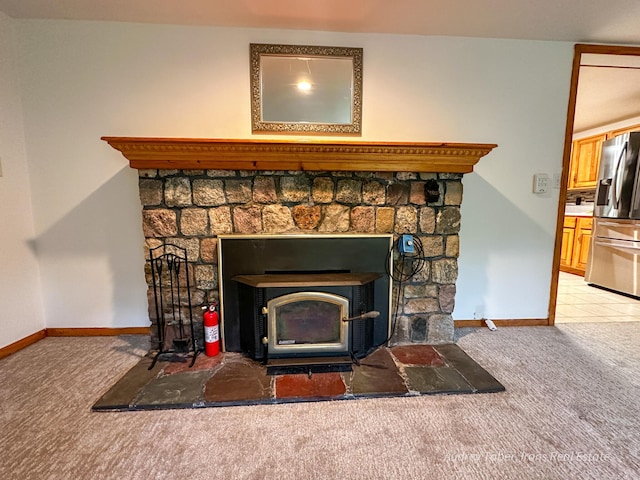 4307 N Mac Rd, Irons, MI 49644 - detailed view of carpet, stainless steel fridge with ice dispenser, a wood stove, and a fire extinguisher