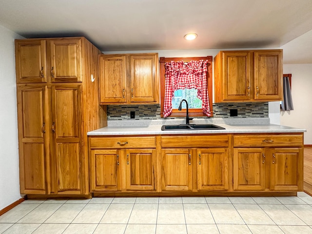 4307 N Mac Rd, Irons, MI 49644 - kitchen with a sink, brown cabinetry, tasteful backsplash, and light countertops