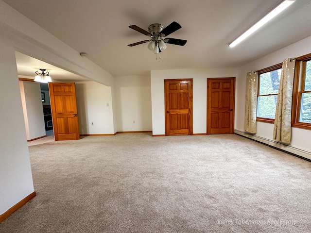 4307 N Mac Rd, Irons, MI 49644 - unfurnished room with baseboards, light colored carpet, baseboard heating, and a ceiling fan