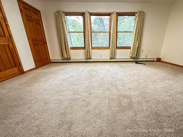 4307 N Mac Rd, Irons, MI 49644 - carpeted spare room featuring healthy amount of natural light, baseboards, and a baseboard radiator