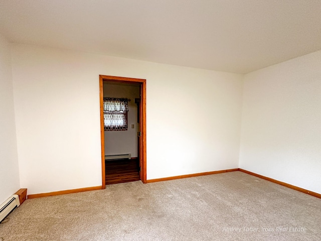 4307 N Mac Rd, Irons, MI 49644 - carpeted spare room with a baseboard heating unit, baseboards, and a baseboard radiator