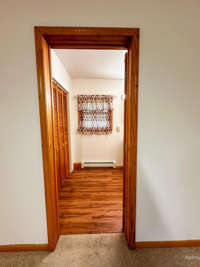 4307 N Mac Rd, Irons, MI 49644 - hallway with a baseboard radiator, carpet, and baseboards