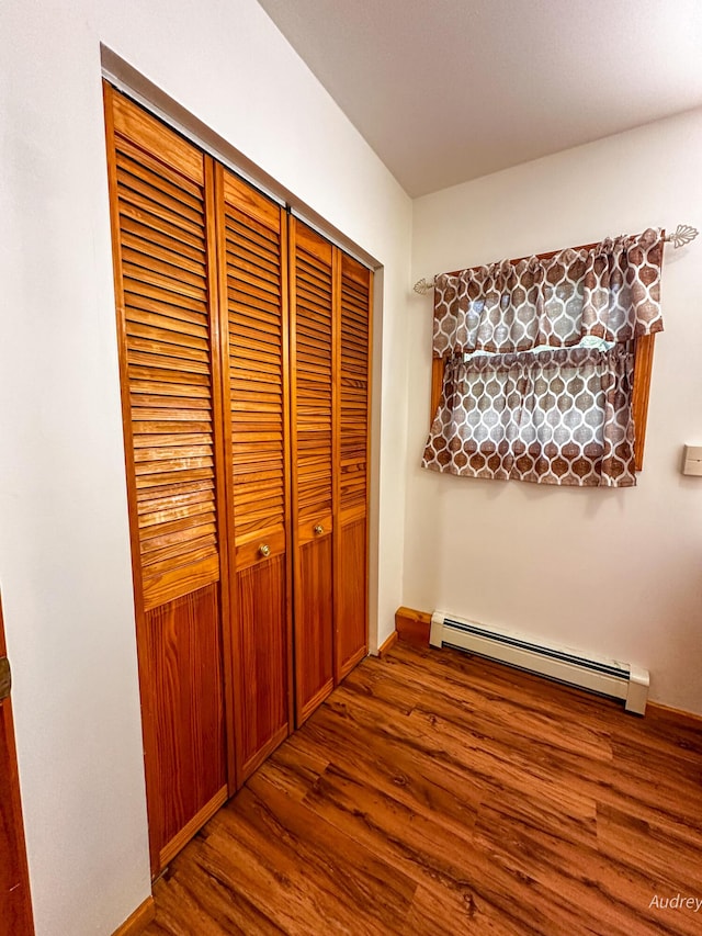 4307 N Mac Rd, Irons, MI 49644 - hall with a baseboard radiator, wood finished floors, and baseboards