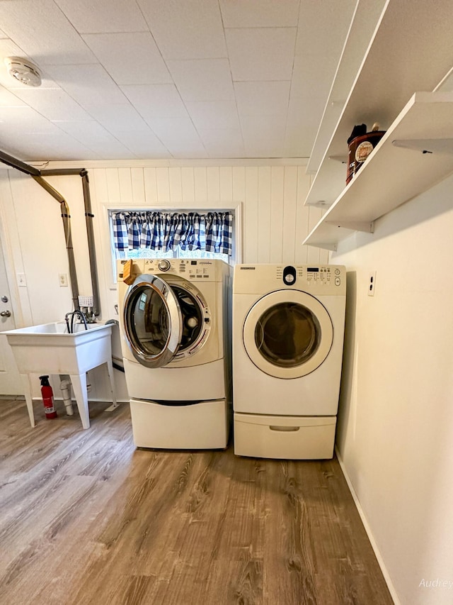 4307 N Mac Rd, Irons, MI 49644 - laundry room with wood finished floors and washer and dryer