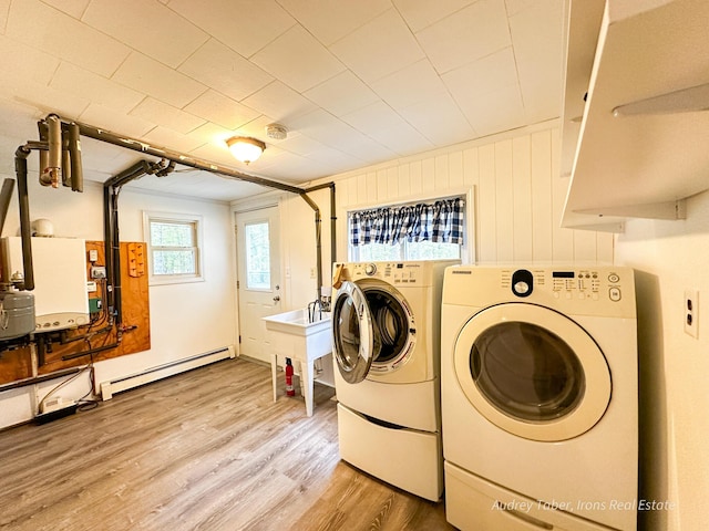 4307 N Mac Rd, Irons, MI 49644 - washroom featuring baseboard heating, washer and dryer, and wood finished floors