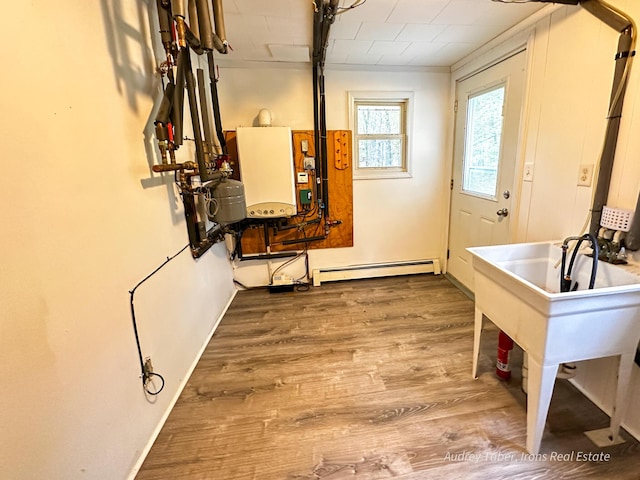 4307 N Mac Rd, Irons, MI 49644 - doorway with a baseboard heating unit, wood finished floors, and water heater