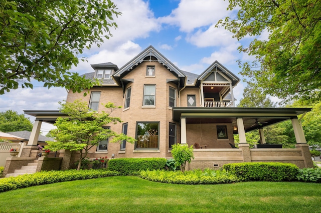 903 Lake Blvd, Saint Joseph, MI 49085 - rear view of house featuring brick siding, a yard, and a balcony