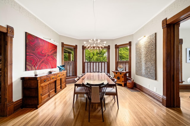903 Lake Blvd, Saint Joseph, MI 49085 - dining space with light wood finished floors, a chandelier, ornamental molding, and baseboards