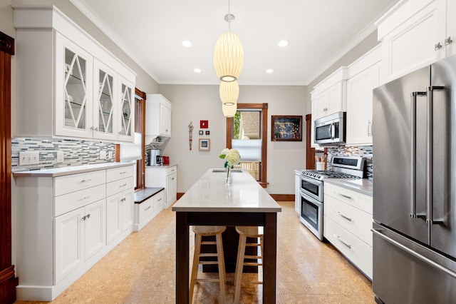 903 Lake Blvd, Saint Joseph, MI 49085 - kitchen with stainless steel appliances, backsplash, a kitchen island, glass insert cabinets, and white cabinets
