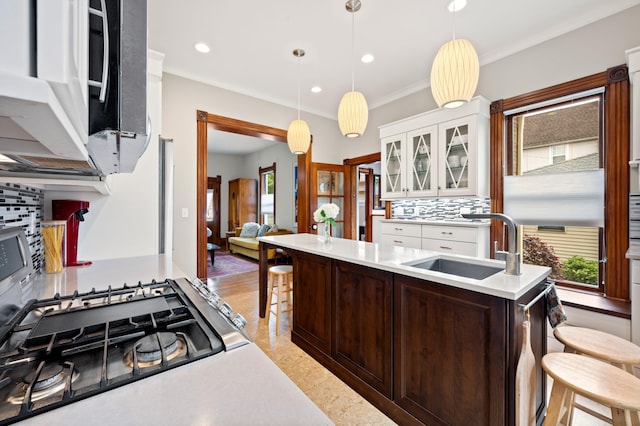 903 Lake Blvd, Saint Joseph, MI 49085 - kitchen featuring decorative backsplash, a kitchen bar, white cabinetry, dark brown cabinetry, and glass insert cabinets