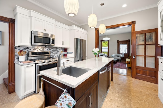 903 Lake Blvd, Saint Joseph, MI 49085 - kitchen featuring stainless steel appliances, a sink, light countertops, white cabinets, and ornamental molding