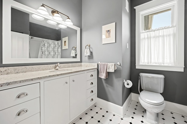 903 Lake Blvd, Saint Joseph, MI 49085 - bathroom featuring vanity, tile patterned floors, toilet, baseboards, and a shower with shower curtain