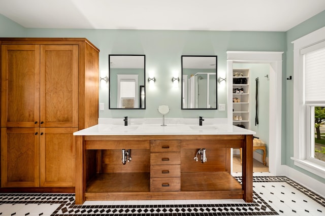 903 Lake Blvd, Saint Joseph, MI 49085 - full bathroom with a closet, double vanity, and baseboards