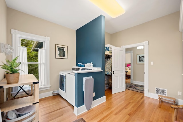 903 Lake Blvd, Saint Joseph, MI 49085 - washroom with washer and dryer, light wood finished floors, and baseboards