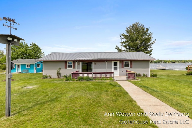171 Dickerson Vw SW, Stanton, MI 48888 - ranch-style house with a front lawn, a wooden deck, and metal roof