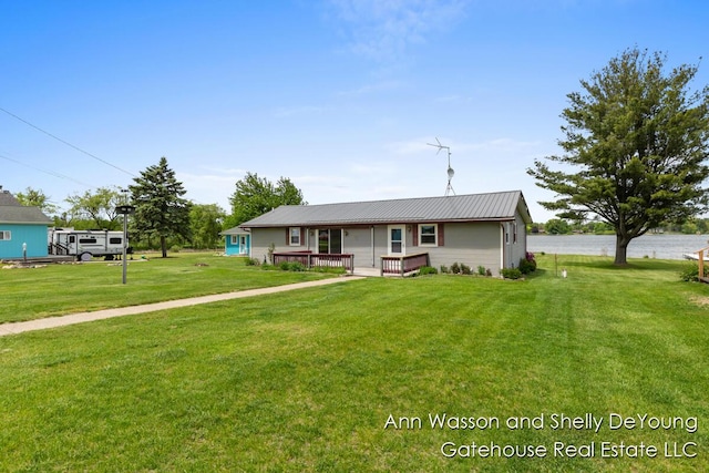 171 Dickerson Vw SW, Stanton, MI 48888 - single story home with a front yard, a deck, and metal roof