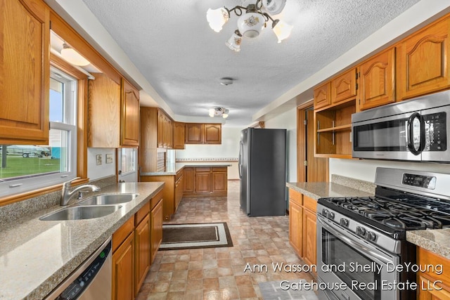 171 Dickerson Vw SW, Stanton, MI 48888 - kitchen featuring stainless steel appliances, a sink, brown cabinetry, a textured ceiling, and open shelves
