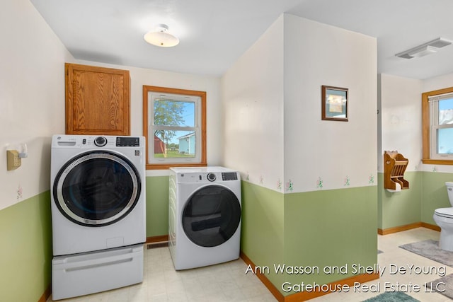 171 Dickerson Vw SW, Stanton, MI 48888 - washroom with washer and clothes dryer, plenty of natural light, and baseboards