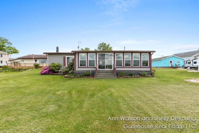 171 Dickerson Vw SW, Stanton, MI 48888 - rear view of house with a lawn and a sunroom