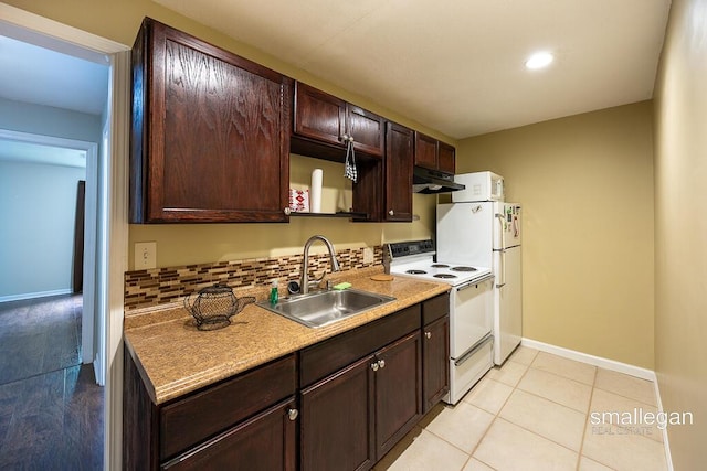 8637 Rainbows End Rd SE, Caledonia, MI 49316 - kitchen with white appliances, under cabinet range hood, dark brown cabinets, light tile patterned floors, and light countertops