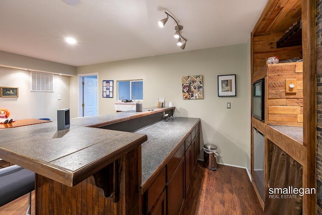 8637 Rainbows End Rd SE, Caledonia, MI 49316 - bar area with dark wood-style floors and baseboards