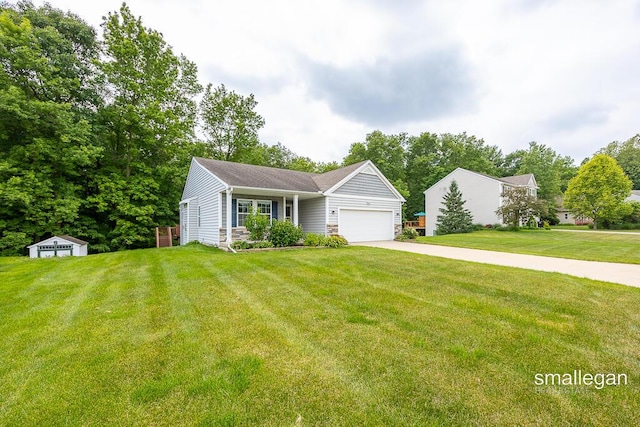 8637 Rainbows End Rd SE, Caledonia, MI 49316 - view of front of house with a garage, a front lawn, concrete driveway, and a storage unit