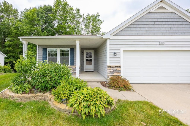 8637 Rainbows End Rd SE, Caledonia, MI 49316 - ranch-style home featuring stone siding, covered porch, an attached garage, and driveway