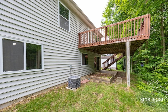 8637 Rainbows End Rd SE, Caledonia, MI 49316 - view of property exterior featuring a wooden deck, stairs, and a vegetable garden