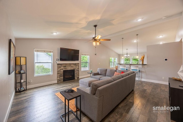 8637 Rainbows End Rd SE, Caledonia, MI 49316 - living area featuring dark wood-style floors, vaulted ceiling, a fireplace, and a ceiling fan