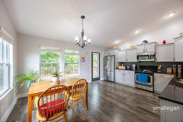 8637 Rainbows End Rd SE, Caledonia, MI 49316 - dining room with a chandelier, dark wood-style floors, lofted ceiling, and recessed lighting