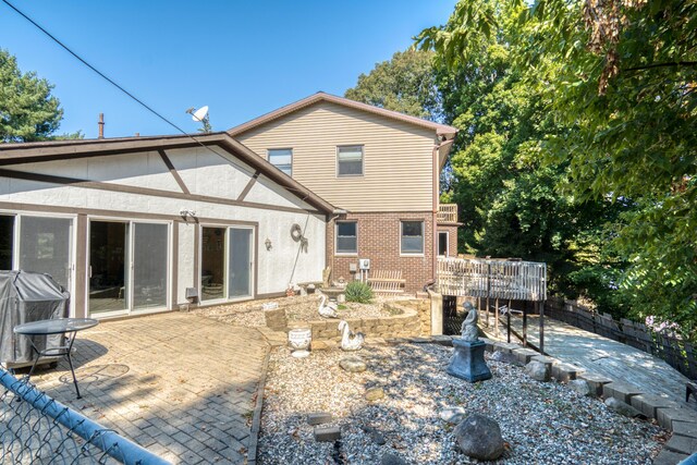 610 Birch St, Big Rapids, MI 49307 - back of house with a patio area, a deck, and stucco siding