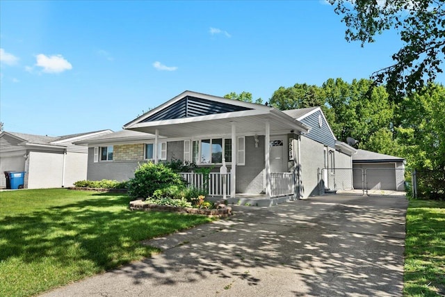 35519 Canyon Dr, Westland, MI 48186 - ranch-style home featuring covered porch, a front lawn, an outbuilding, a detached garage, and brick siding