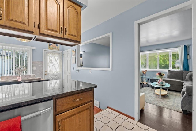 35519 Canyon Dr, Westland, MI 48186 - kitchen featuring dark stone counters, plenty of natural light, light wood finished floors, and dishwasher