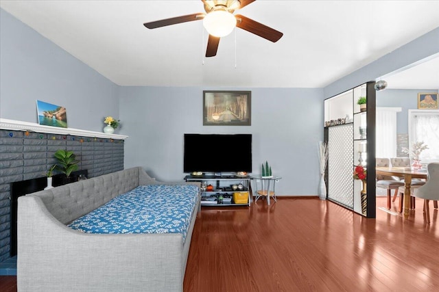 35519 Canyon Dr, Westland, MI 48186 - living room with wood finished floors, a brick fireplace, and a ceiling fan