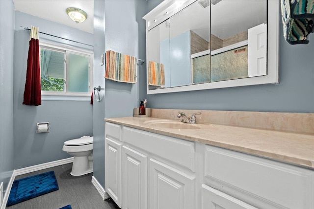 35519 Canyon Dr, Westland, MI 48186 - bathroom featuring baseboards, toilet, a tile shower, and vanity